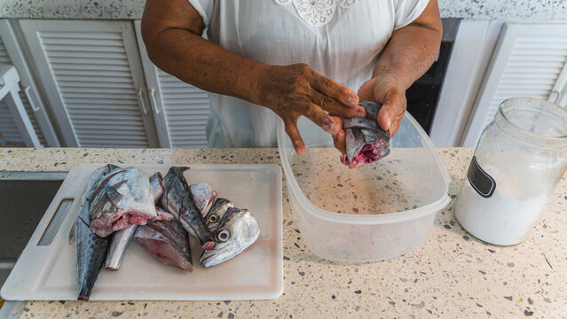 Preparing fresh tropical fish in Caribbean kitchen