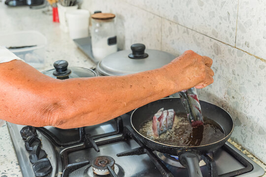 Frying fresh fish in a tropical Caribbean kitchen