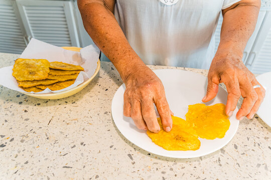 Preparing traditional Caribbean plantain slices