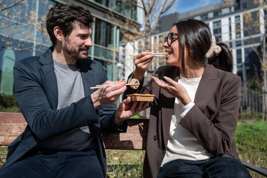 Colleagues sharing lunch break outdoors, business collaboration