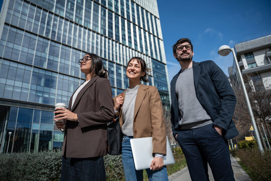 Business colleagues commuting together near modern office tower