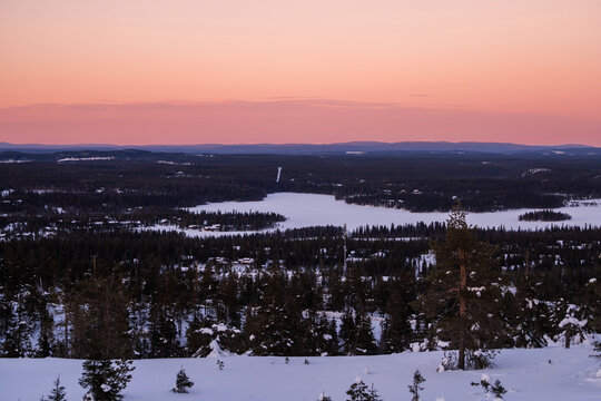 Winter lake and forest panorama at dusk in Finland