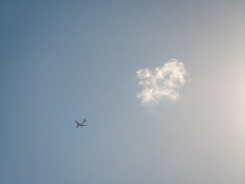 Airplane flying through clear blue winter sky
