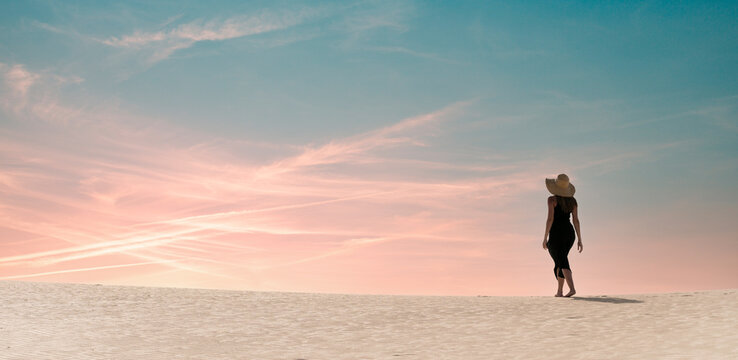 Woman walking on dune at sunset in Corralejo, Fuerteventura