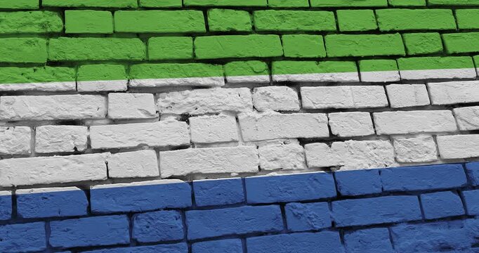 A panning video of a brick wall with the sierra leone flag
