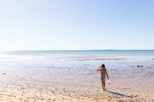 young boy exploring coastline, Vilankulos, Mozambique, Africa