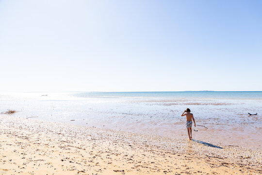 young boy exploring coastline, Vilankulos, Mozambique, Africa