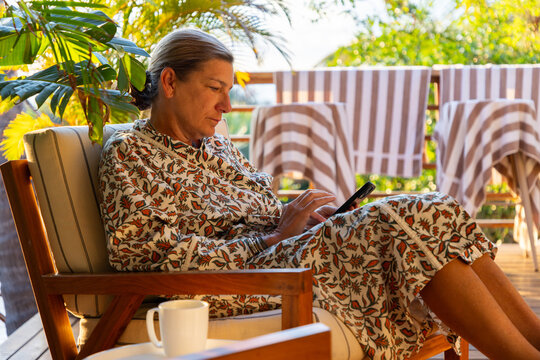 Woman holding coffee cup, relaxing, Vilankulos, Mozambique, Africa