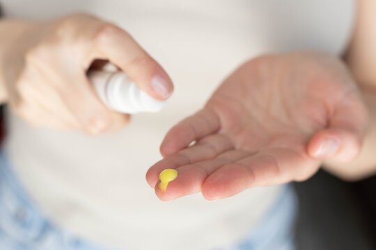 Closeup of a woman using retinal serum.