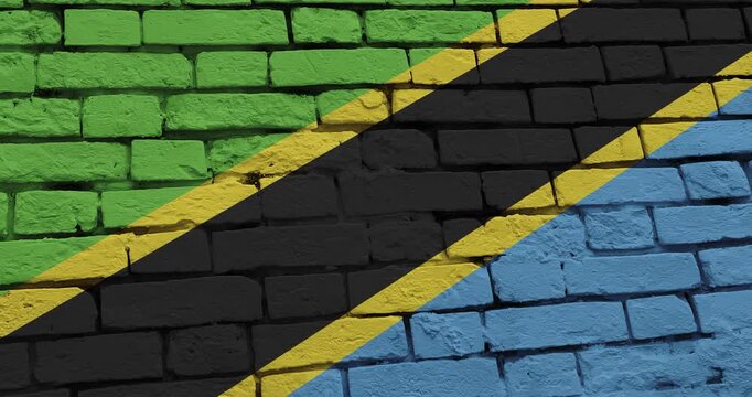 A panning video of a brick wall with the tanzania flag