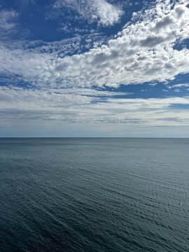 Calm blue sea and cloudy sky. 