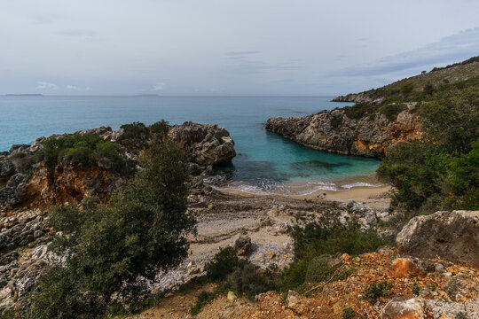 Aquarium bay with beach and rock formations on the Adriatic sea coast with turquoise colored water near Himare, Albania