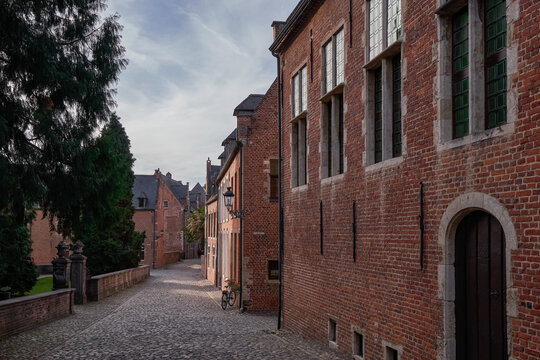 Historic brick facades and cobblestone street in Groot Begijnhof - Leuven, Belgium
