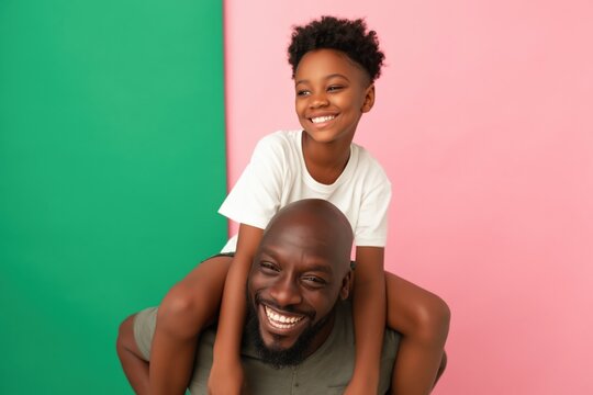 Father giving daughter piggyback ride in studio with panels