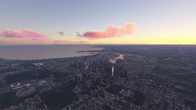 Side aerial drone view at sunset of Melbourne city in Victoria. Australia