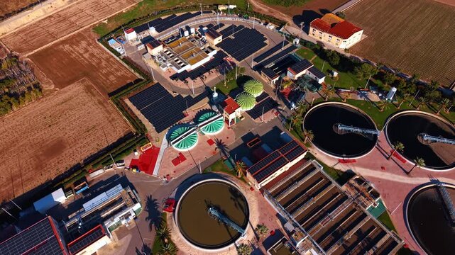 Footage over the water treatment facility. Drone flight over sewage reservoirs on sunny day.