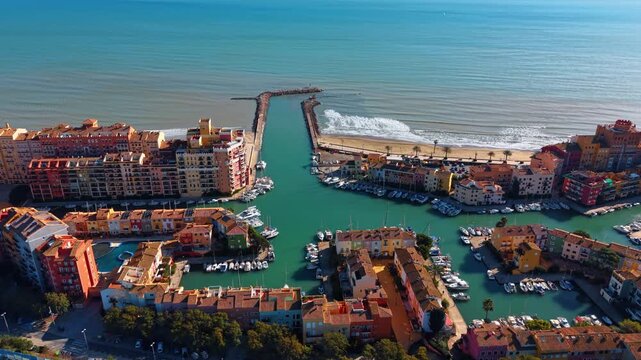 Network of canals and brightly colored waterfront houses in Little Venice of Valencia. Drone flight over Port Saplaya, Valencia, Spain.