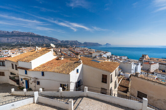 Panoramic view of Altea with tiled roofs, Mediterranean sea and Penon de Ifach.