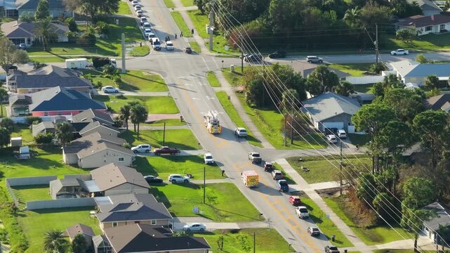 Aerial view of Florida rescue vehicle in motion during emergency call, equipped with active lights and department markings.
