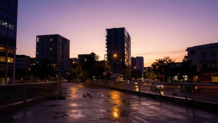 Obraz premium Urban street with wet reflective pavement on city bridge at dusk