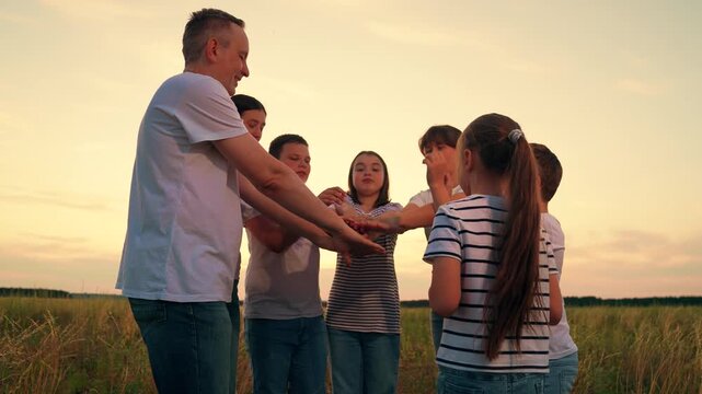 Winning team. Family celebration. People, teamwork, in nature park. Happy family, parents children, raise their hands outside. Parents, mother, father, children raise their hands in sign family unity