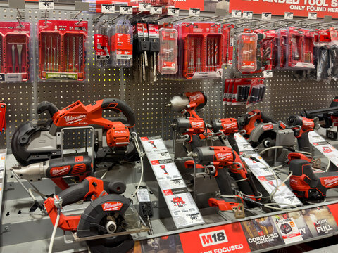 Prosper, Texas, USA - April 1st, 2026: Specialized red Milwaukee M18 Fuel cordless band saw and impact wrenches standing on shelf near drill bits in The Home Depot