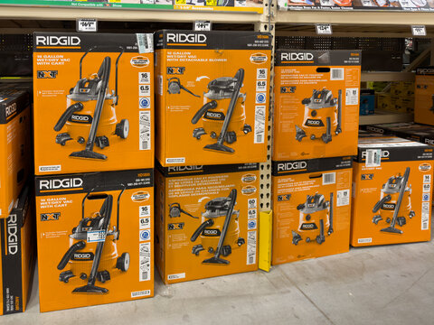 Prosper, Texas, USA - April 1st, 2026: Multiple orange boxes containing Ridgid NXT 14 and 16 gallon wet dry vacuum cleaners stacked on floor in The Home Depot