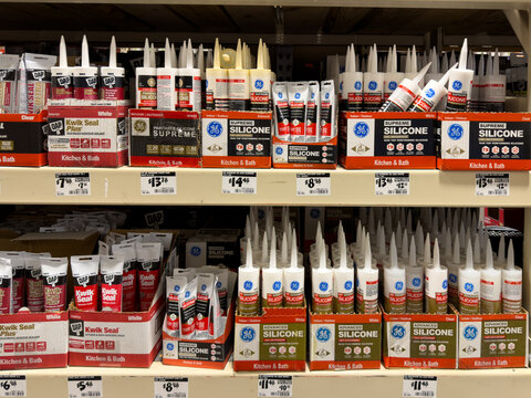 Prosper, Texas, USA - April 1st, 2026: Assorted ge and dap kitchen and bath silicone sealants displayed in cardboard boxes on metal shelving in The Home Depot
