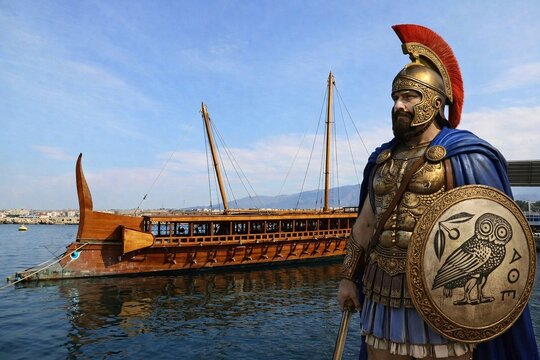 The ancient Greek admiral Themistoklis, who won the naval battle of Salamis in 480 BCE, next to an ancient trireme warship