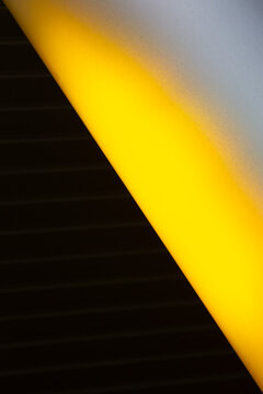 View of striking geometric contrast with a bright yellow beam slicing through a dark, textured surface, creating a bold visual statement, Almere, Flevoland, Netherlands.