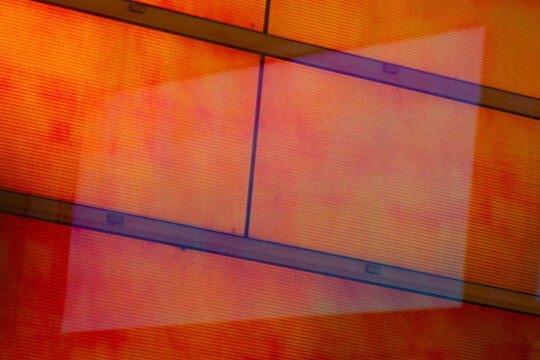 View of geometric abstraction featuring orange and red hues overlaid with a translucent rectangular form, creating depth and visual intrigue, La Defense, Flevoland, Netherlands.