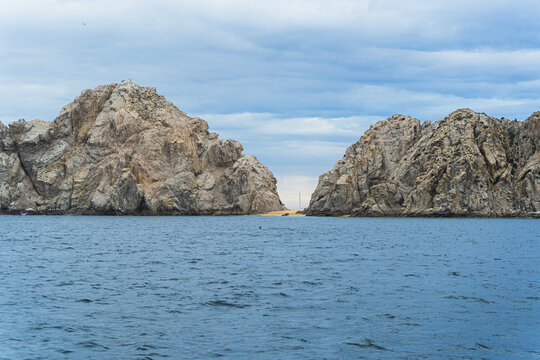 Beautiful isle at Cabo St. Lucas, Mexico with ocean as foreground and cloud as background. Landscape photography