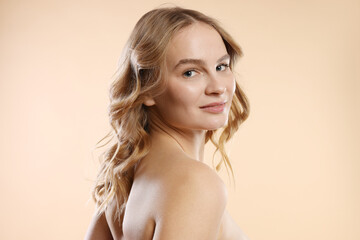 Naklejka premium Portrait of beautiful woman on beige background