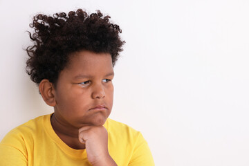Obraz premium Resentful little boy on light grey background. Space for text