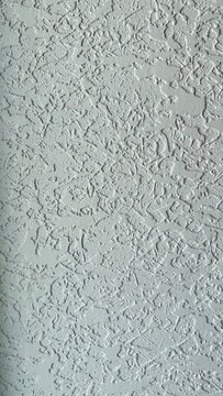 Grey stucco wall texture with rough knockdown plaster finish for architectural design and renovation