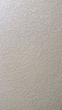 Grey stucco wall texture with rough knockdown plaster finish for architectural design and renovation