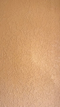 Peach stucco wall texture with rough knockdown plaster finish for architectural design and Mediterranean house renovation