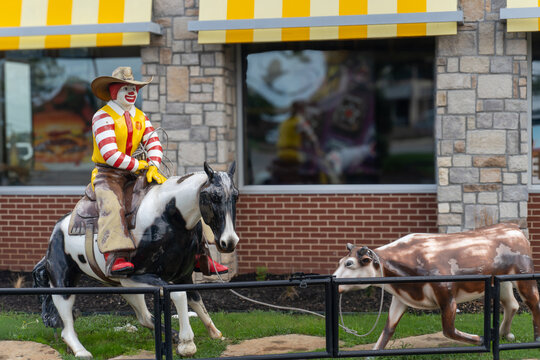 Weatherford, Texas: A western-theme McDonald's features an outdoor statue of Ronald McDonald lassoing a calf. Cowboy Ronald McDonald with cowboy hat riding a horse.