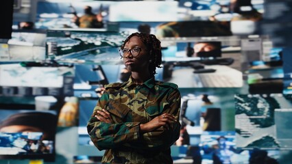 Obraz premium Military officer in war room oversees mission operations on digital displays. Army soldier stands in front of command screens used for surveillance and threat monitoring, camera A close up
