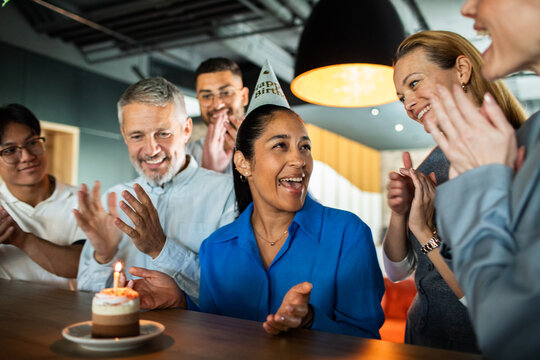 Coworkers celebrating birthday in modern office