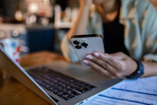 Person managing finances on smartphone at home