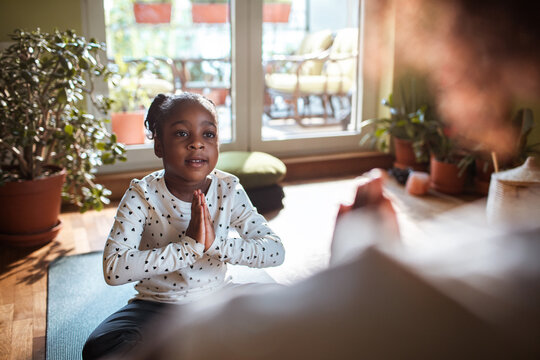 Young girl practicing yoga and mindfulness at home