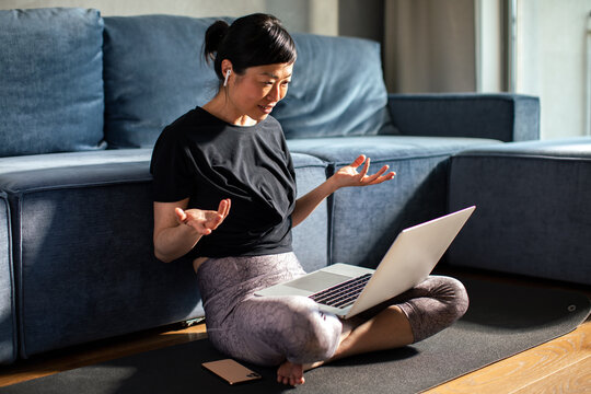 Woman on video call with laptop at home