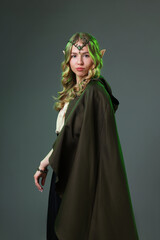 Naklejka premium Beautiful girl dressed as elf on grey background