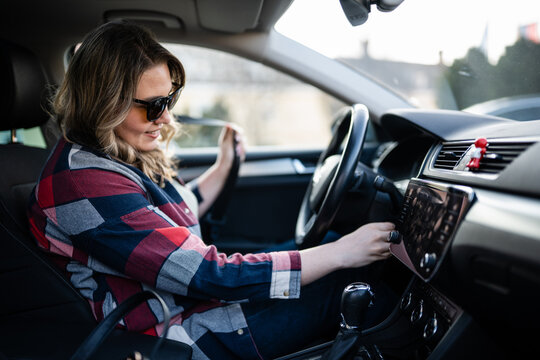 Woman starting car, preparing for road trip drive