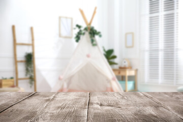 Empty wooden table in playroom, selective focus. Space for design © New Africa