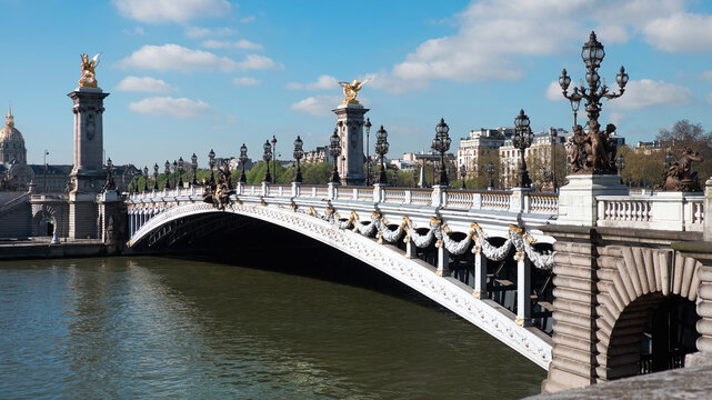 Pont Alexandre III bridge over Seine ornate lamps and gilded sculptures in spring