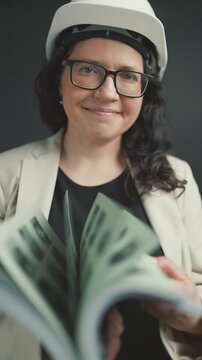 Professional female architect checking technical documentation