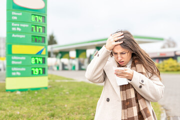 Fuel inflation concept woman shocked by gas receipt © Maksym