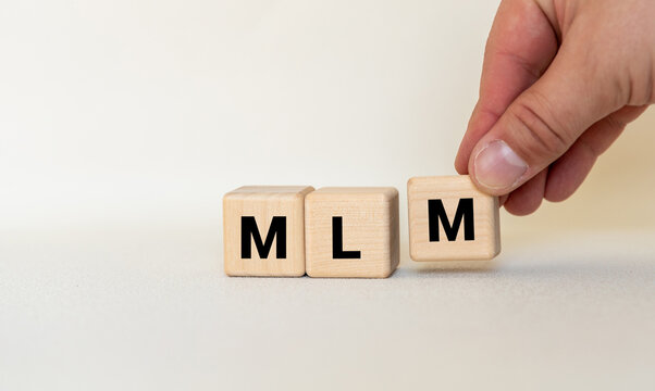 Wooden letters spelling MLM, business mlm concept.
